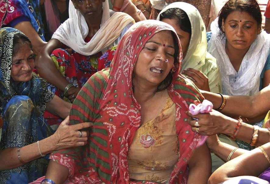 Rajesh Chand, mother of Rajan Chand, a teen who was killed after a kite flying row, wails in New Delhi.