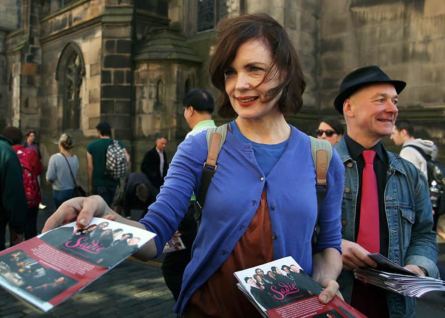 Actress famed for her appearance in British period TV series Downton Abbey, Elizabeth McGovern hands out flyers on Edinburgh`s Royal Mile to promote her band Sadie and the Hotheads, who are performing during the Edinburgh Fringe Festival, in Edinburgh, Scotland.