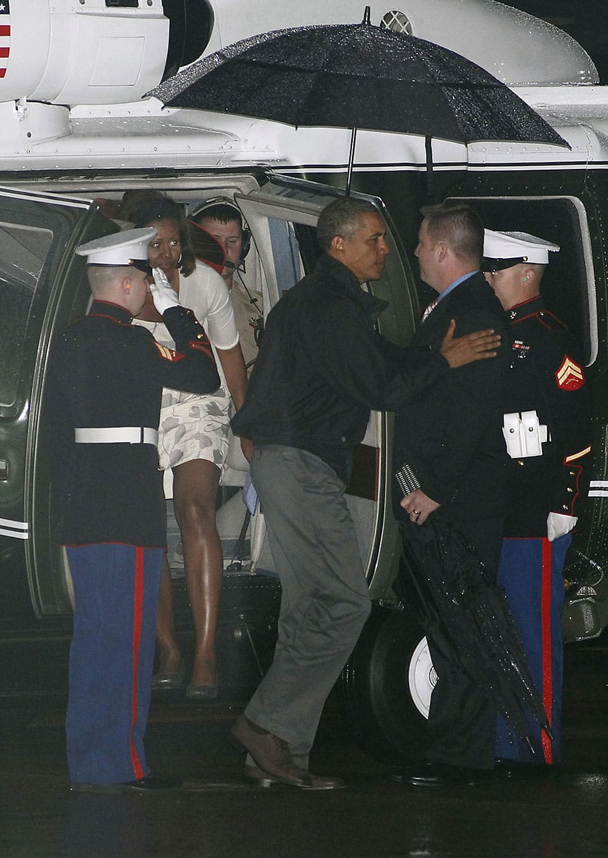 President Barack Obama, and first lady Michelle Obama exit Marine One at the Cape Cod Coast Guard Station in Bourne, Mass., after ending his vacation on Martha`s Vineyard.