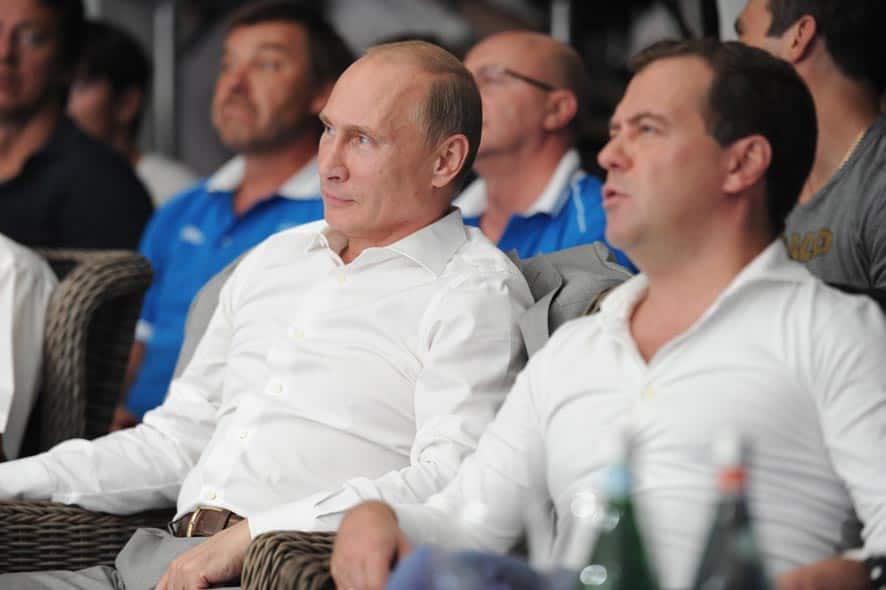 Russian President Vladimir Putin, left, and Russian Prime Minister Dmitry Medvedev watch League S-70 mixed martial arts fighting competition at Russia`s Black Sea resort of Sochi.