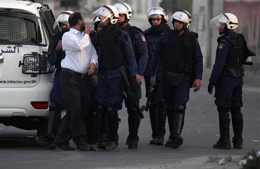 Riot police detain a Bahraini anti-government protester, who was later released, during a planned protest in Muqshaa village, Bahrain. Stepped-up protests nationwide continued for the forth day amid heavy security.