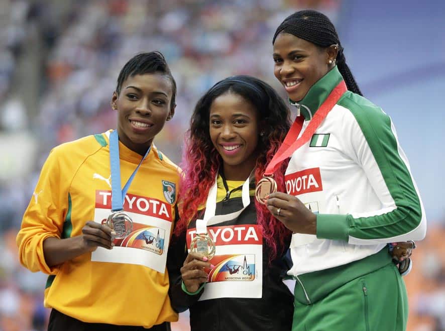 Ivory Coast`s Murielle Ahoure, Jamaica`s Shelly-Ann Fraser-Pryce and Nigeria`s Blessing Okagbare pose on the podium during the medals ceremony for the women`s 200-meter at the World Athletics Championships in the Luzhniki stadium in Moscow, Russia.