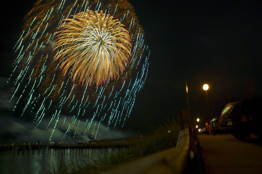 Fireworks explode overhead near where President Barack Obama and the first family were watching the display from inside Valerie Jarrett`s rental house, in Oak Bluffs, Mass. during the Obama`s family vacation on the island of Martha`s Vineyard.