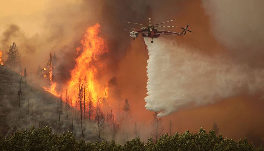 Helicopters battle the 64,000 acre Beaver Creek Fire north of Hailey, Idaho. A number of residential neighborhoods have been evacuated because of the blaze.