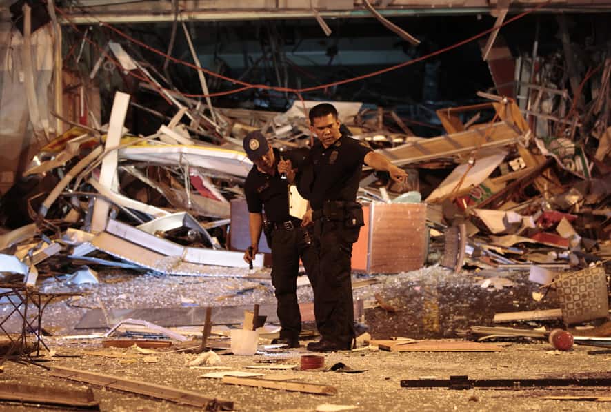 Police check an area where an explosion occured inside a restaurant in suburban San Juan, east of Manila, Philippines.
