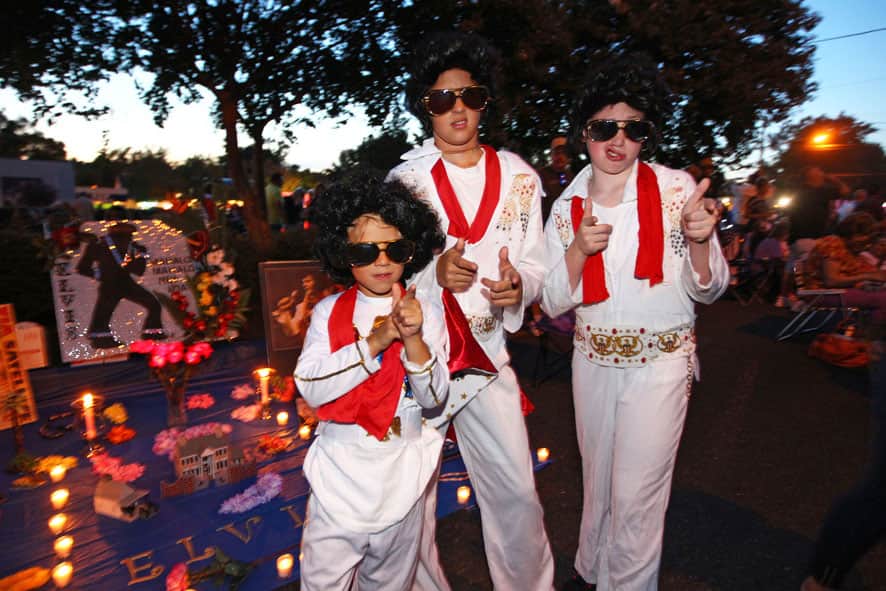 Nicholas Woodlief, 7, left, his sister Annabelle Woodlief, 11, and friend, Eli Crain, 11, right, strike an Elvis Presley pose at Graceland, Presley`s home, before the annual candlelight vigil, in Memphis, Tenn.