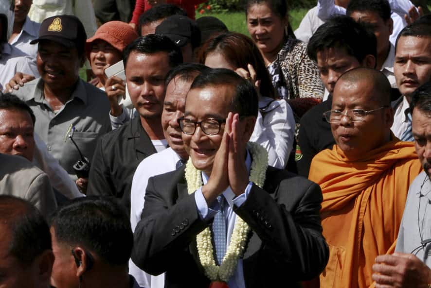 Opposition Cambodia National Rescue Party leader Sam Rainsy greets his supporters upon his arrival at Phnom Penh International Airport, in Phnom Penh, Cambodia.