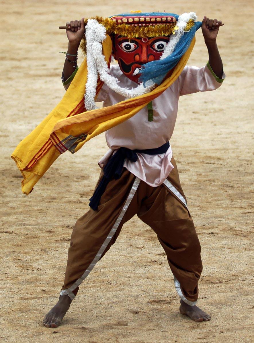 A student in traditional attire performs during a function to mark India`s Independence Day in Bangalore.