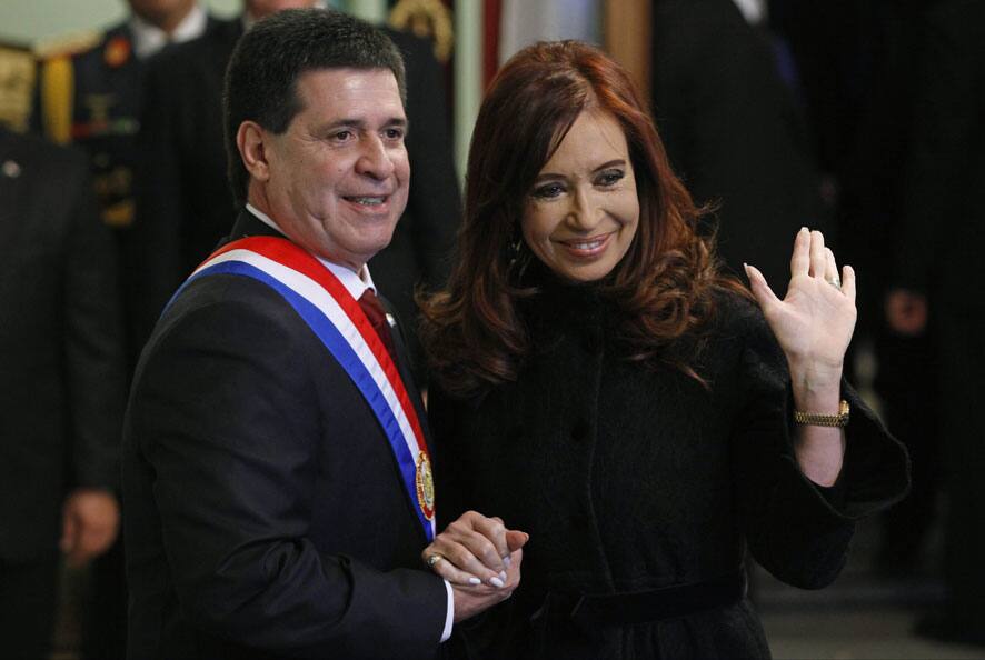 Argentina`s President Cristina Fernandez, right, waves as she poses for photos with Paraguay`s new President Horacio Cartes during his swearing-in ceremony at Palacio de Lopez presidential palace in Asuncion, Paraguay.