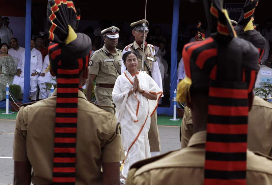 West Bengal state Chief Minister Mamata Banerjee, center, gestures as she inspects the parade during India`s Independence Day celebrations in Kolkata.