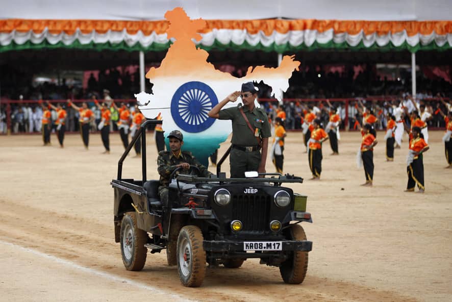 An Indian school student dressed in military attire takes the salute as he performs with others during a function to mark India`s Independence Day in Bangalore.