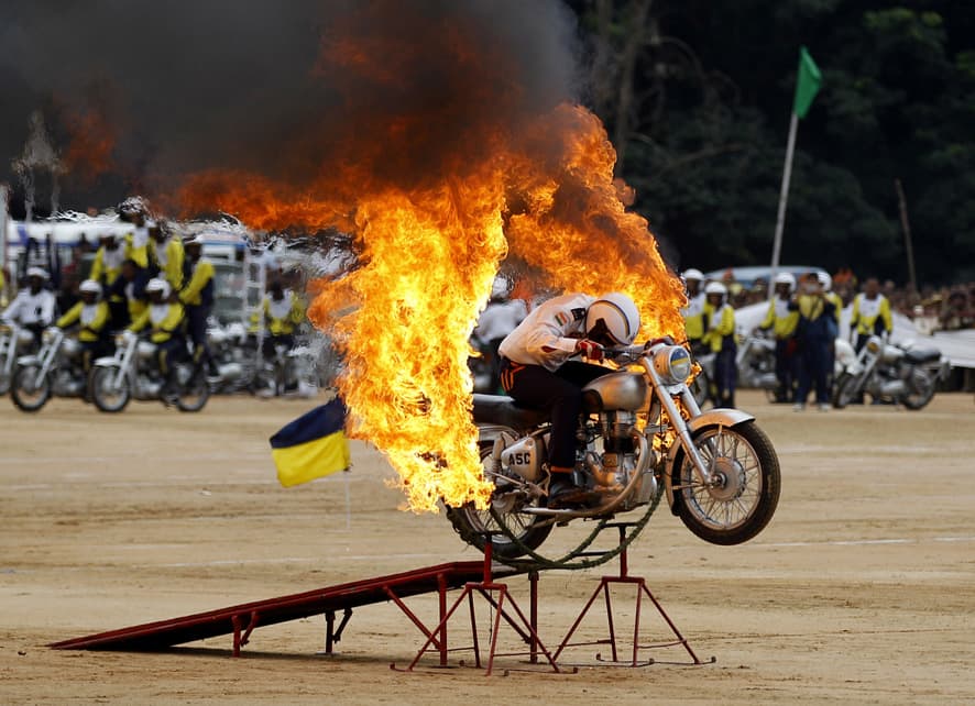 An Indian army officer drives through a burning ring during a function to mark India`s Independence Day in Bangalore.