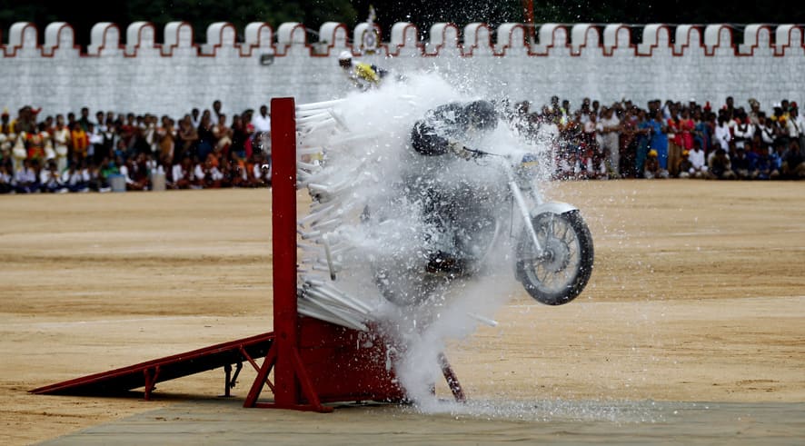 An Indian army officer performs a stunt on a motorcycle during a function to mark India`s Independence Day in Bangalore.