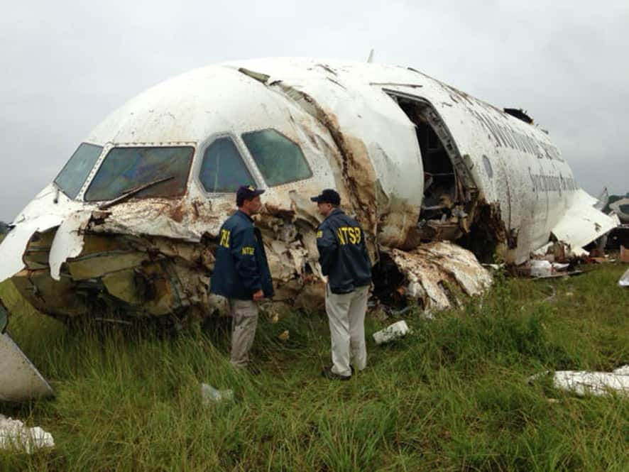 National Transportation Safety Board (NTSB) Investigators examine debris of a UPS A300 cargo plane after it crashed on approach at Birmingham-Shuttlesworth International Airport in Birmingham, Ala.