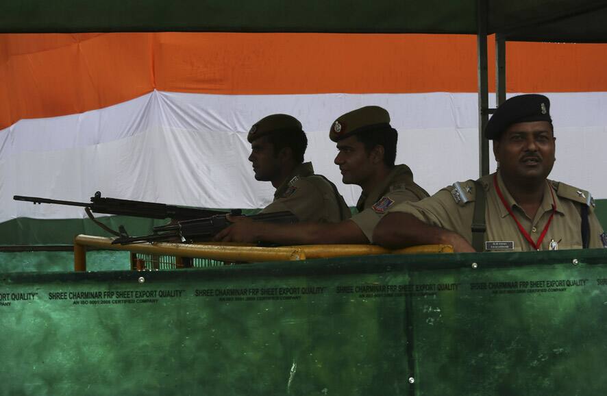 Policemen stand guard as the area near the India Gate monument is draped with colors of the Indian flag ahead of Independence Day in New Delhi.