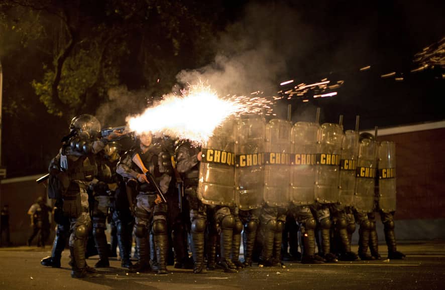 Riot police officers fire tear gas canisters during a protest against the governor of Rio de Janeiro state, Sergio Cabral, outside the Guanabara Palace in Rio de Janeiro, Brazil.