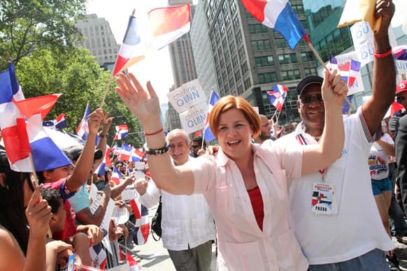 Christine Quinn, running in the New York City Mayors race, center, interacts with the crowd as she makes her way up New York`s Avenue of the Americas during the Dominican Day Parade.