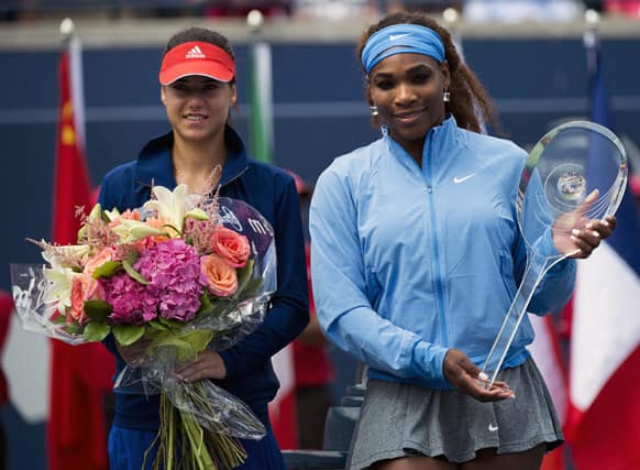 Serena Williams, right, of the United States, poses for photographs after winning the women`s singles championship at the Rogers Cup tennis tournament by defeating Sorana Cirstea, left, of Romania, in Toronto.
