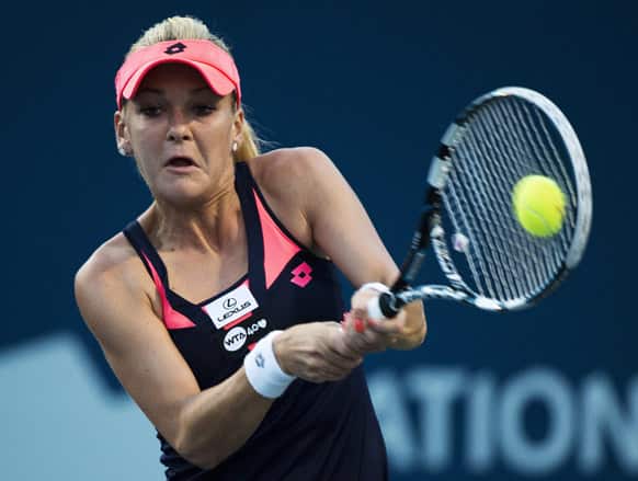 Agnieszka Radwanska, of Poland, returns the ball against Serena Williams, of the United States, during a semifinal of the Rogers Cup women`s tennis tournament in Toronto.