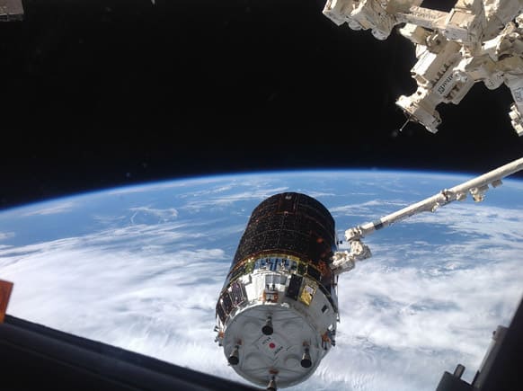 The International Space Station`s Canadarm2 grapples the unpiloted Japanese