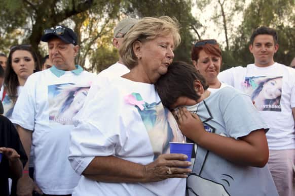 Sara Britt, grandmother of Hannah Anderson, 16, and Hannah`s brother Ethan Anderson, 8, both possibly kidnapped, hugs Ethan`s best friend Christian