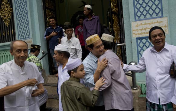 Myanmar Muslims greet each other after offering prayer to mark the celebration of Eid al-Fitr, the end of holy fasting month of Ramadan in Yangon.