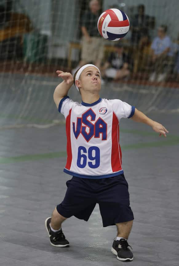 John Horton, a member of the United States volleyball team, serves during a game against the European volleyball team at the 2013 World Dwarf Games in East Lansing, Mich.