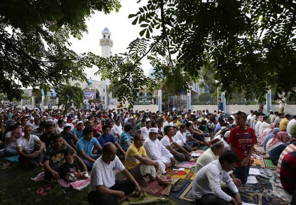 Filipino Muslims attend a prayer at the Blue Mosque to mark the celebration of Eid, the end of holy fasting month of Ramadan at suburban Taguig city, east of Manila, Philippines.