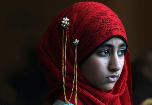 Ayesha Dawood, 12, quietly leaves Reliant Center after the Eid ul Fitr prayer service and celebration in Houston.