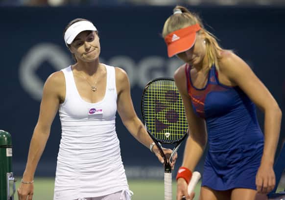 Martina Hingis of Switzerland and Daniela Hantuchova of Slovakia react during their loss to Julia Goerges, of Germany, and Barbora Zahlavova Strycova, of the Czech Republic, in a doubles match at the Rogers Cup women`s tennis tournament Thursday, Aug. 8, 2013, in Toronto.