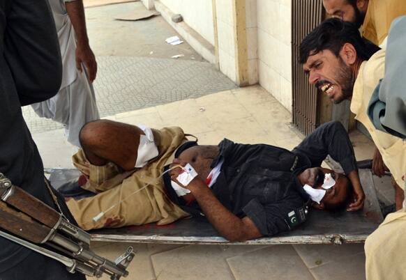 Pakistani`s carry an injured police officer from the site of a bombing in Quetta. A suicide bomber attacked a funeral for a policeman in southwestern Pakistan on Thursday, killing at least tens of people, including a senior police officer, and wounding over 60, police said.