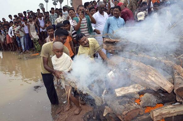 Vivek Kumar lights the pyre of his father Indian army soldier Vijay Kumar Rai, allegedly killed by Pakistani soldiers, on the banks of the Ganges River in Patna.