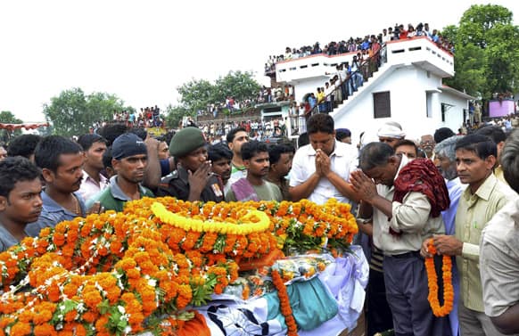 People pay their last respects in front of the coffin of Indian army soldier Vijay Kumar Rai, allegedly killed by Pakistani soldiers, before his cremation in Danapur, on the outskirts of Patna.