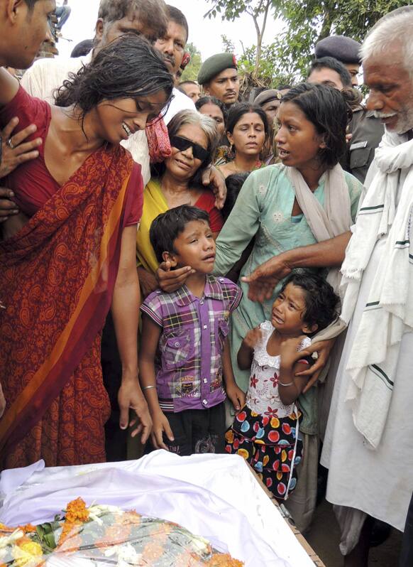 The wife and children of Indian army soldier Vijay Kumar Rai, allegedly killed by Pakistani soldiers, cry near his coffin in Danapur, on the outskirts of Patna.