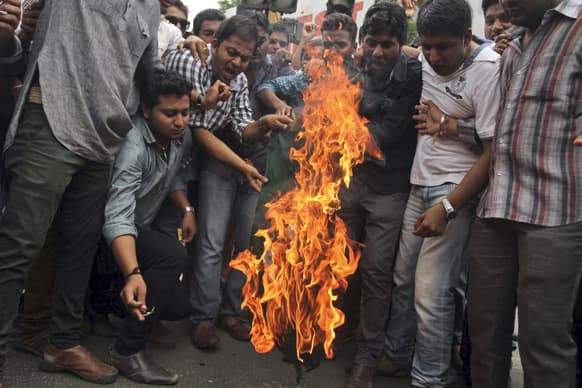 Activists of the student wing of Bharatiya Janata Party (BJP) burn a Pakistani flag during a protest in Ahmadabad.