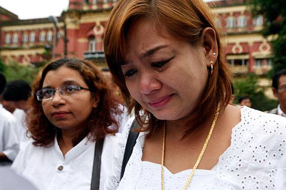 A member of Myanmar prominent 88 generation students group cries as they salute during a gathering to mark the 25th anniversary of Myanmar`s pro-democracy uprising in Yangon, Myanmar.