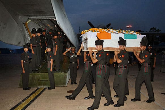 Indian soldiers carry the coffin of one of their colleagues after his remains were returned at the Palam Technical Airport in New Delhi.