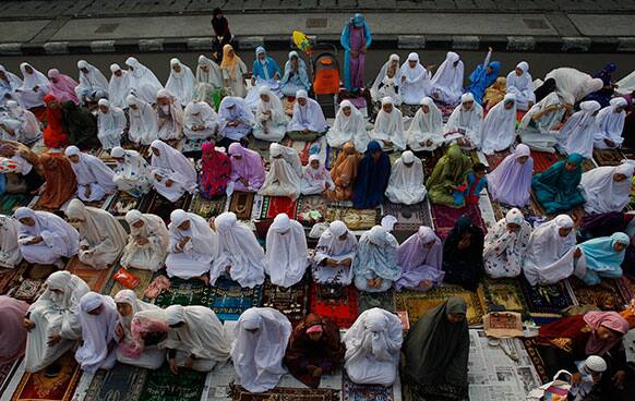 Muslims gather after Eid al-Fitr prayers that marks the end of the holy fasting month of Ramadan in Jakarta, Indonesia.