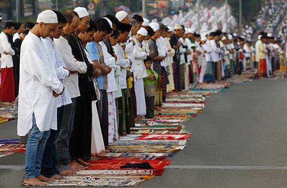 Muslims offer Eid al-Fitr prayers that marks the end of the holy fasting month of Ramadan in Jakarta, Indonesia.