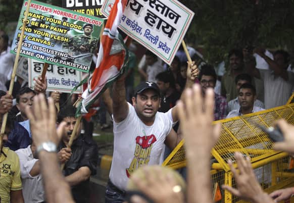 Activists of Congress party`s youth wing shout slogans during a protest against the death of five Indian army soldiers in cross-border exchanges, New Delhi.