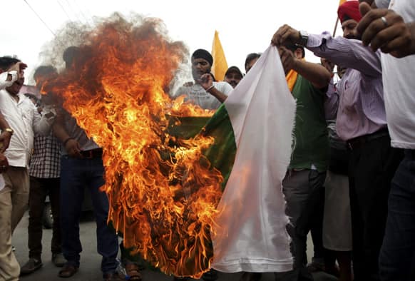 Activists of Shiv Sena burn a Pakistani flag during a protest against the death of five Indian army soldiers in cross-border exchanges, in Jammu.