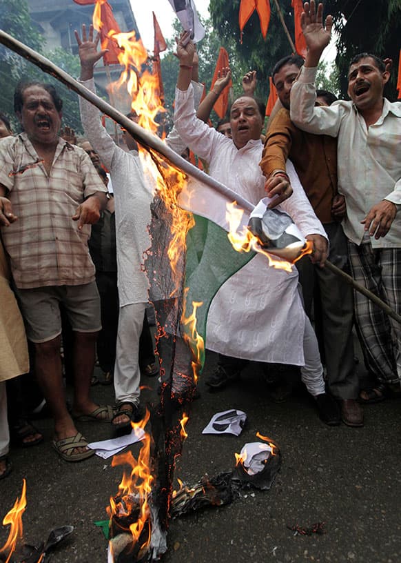 Activists of the Indian right-wing Hindu organization Shiv Sena shout slogans as they burn a Pakistani flag during a protest against the death of five Indian army soldiers in cross-border exchanges, in Jammu.