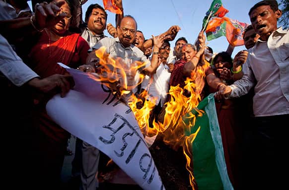 Activists of Bharatiya Janata Party shout slogans and burn a representation flag of Pakistan during a protest against the death of five Indian army soldiers in cross-border exchanges, in Allahabad.