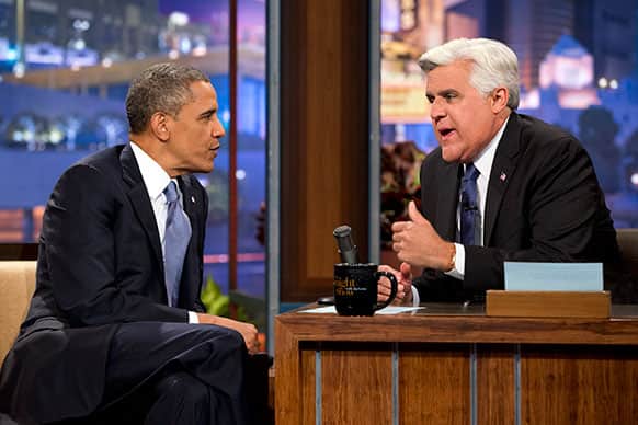 President Barack Obama talks with Jay Leno during a commercial break during the taping of his appearance on “The Tonight Show with Jay Leno” in Los Angeles.
