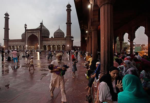 Muslim devotees wait for Iftar, the meal that breaks the day long fast during holy Ramadan at the Jama Masjid, or the Grand Mosque, in New Delhi.