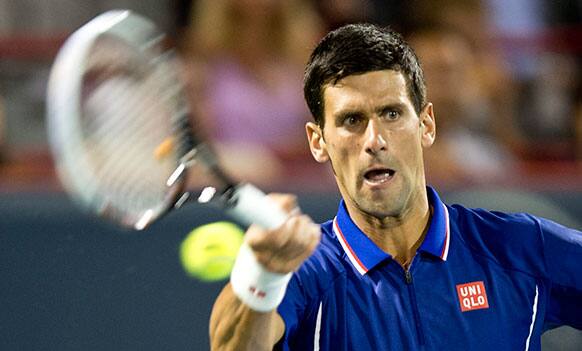 Novak Djokovic from Serbia, returns to Florian Mayer from Germany, at the Rogers Cup men`s tennis tournament.