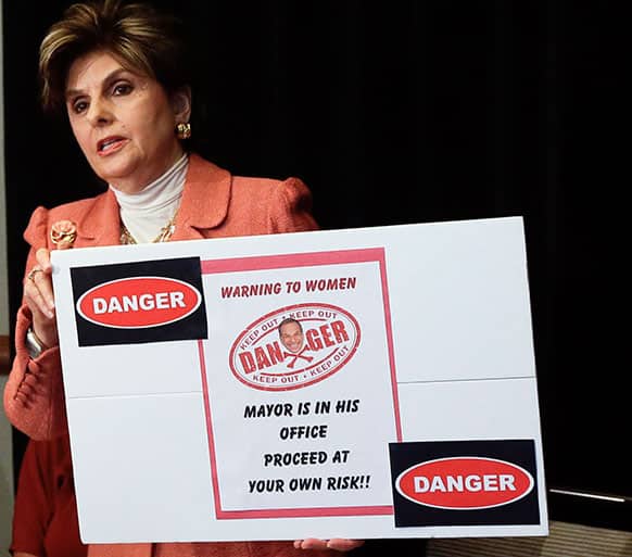 Attorney Gloria Allred holds a sign alluding to San Diego Mayor Bob Filner during a news conference in San Diego.