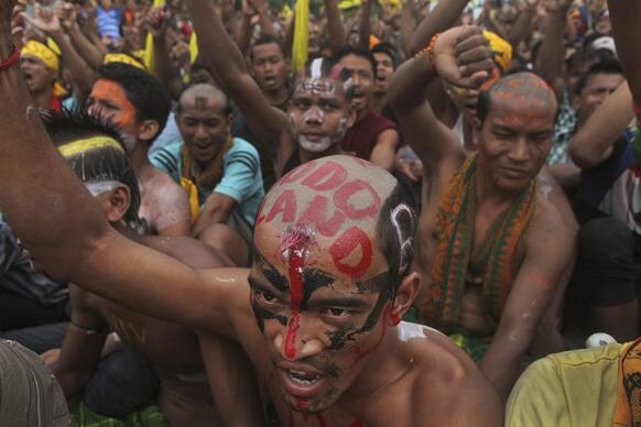 All Bodo Students Union activists shout slogans as they demand the creation of new state called “Bodoland” during a mass rally on a national highway in Barama, in lower Assam.