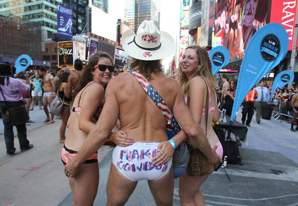 Robert John Burck, also known as the Naked Cowboy and two unidentified women are seen at the 11th annual national Underwear Day in New York.