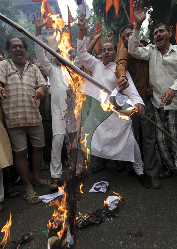 Activists of the Shiv Sena shout slogans as they burn a Pakistani flag during a protest against the death of five Indian army soldiers in cross-border exchanges, in Jammu.